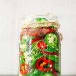 Mason jars of homemade fermented vegetables on a shelf